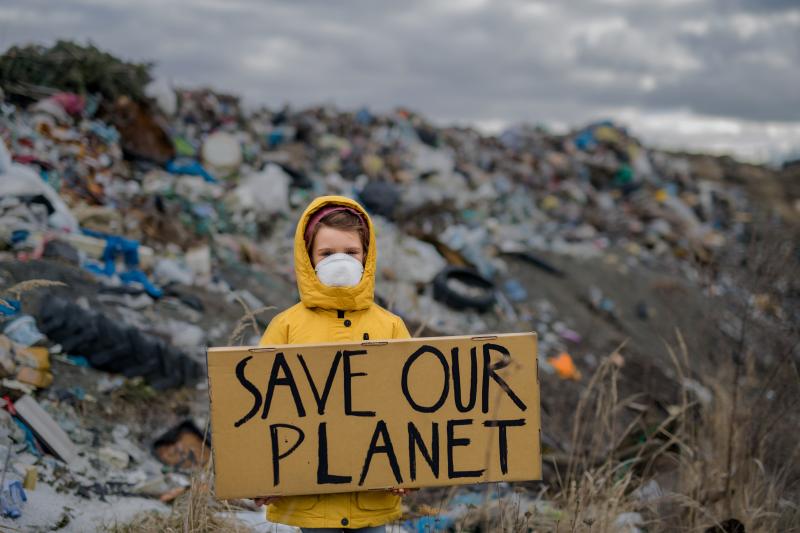 Child holding save our planet sign