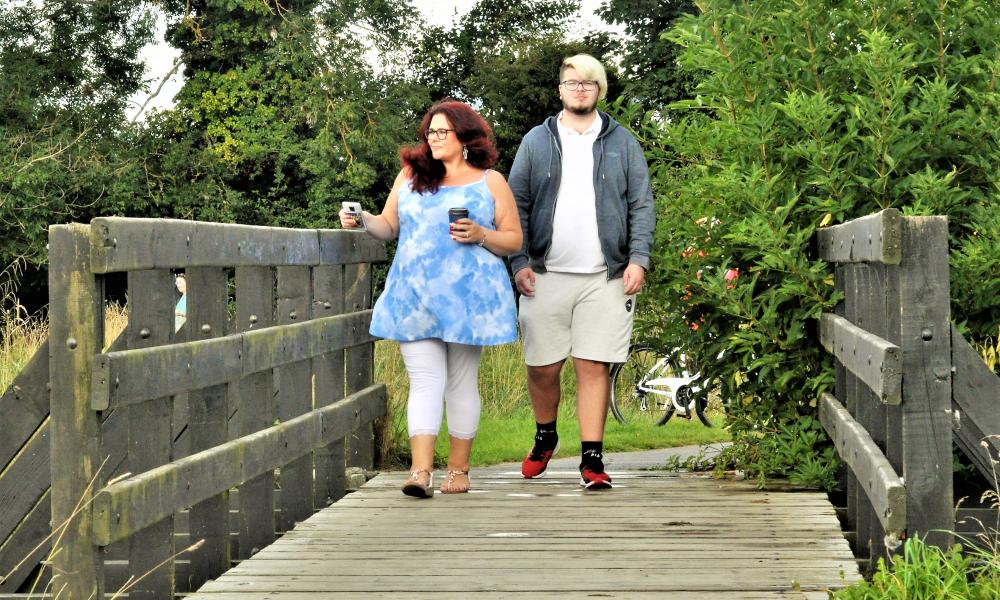Man and woman on wooden bridge