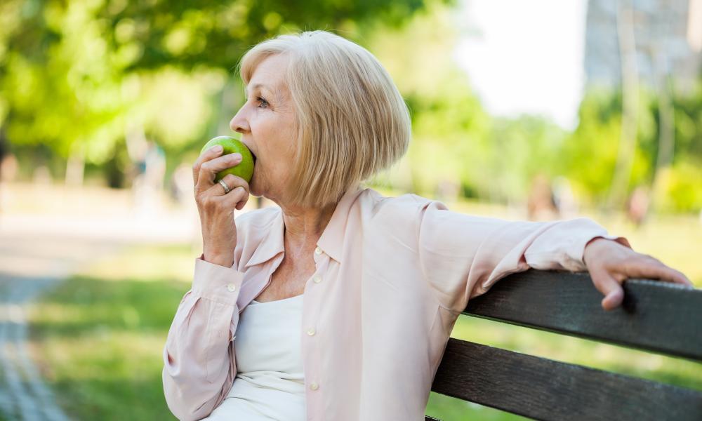 Older lady eating apple