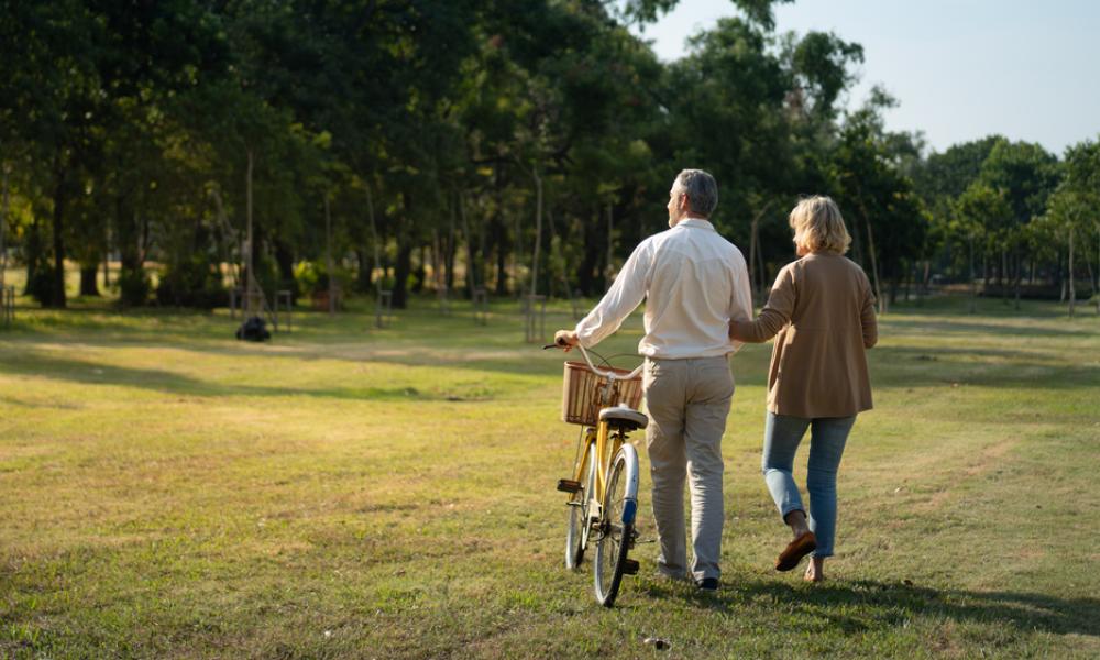 Older couple in field with bike