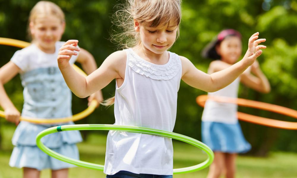 Young girls playing hula hoops