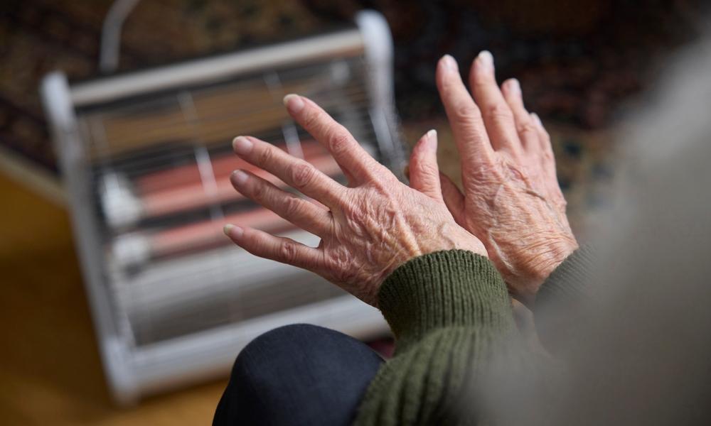 Heating hands in front of electric fire