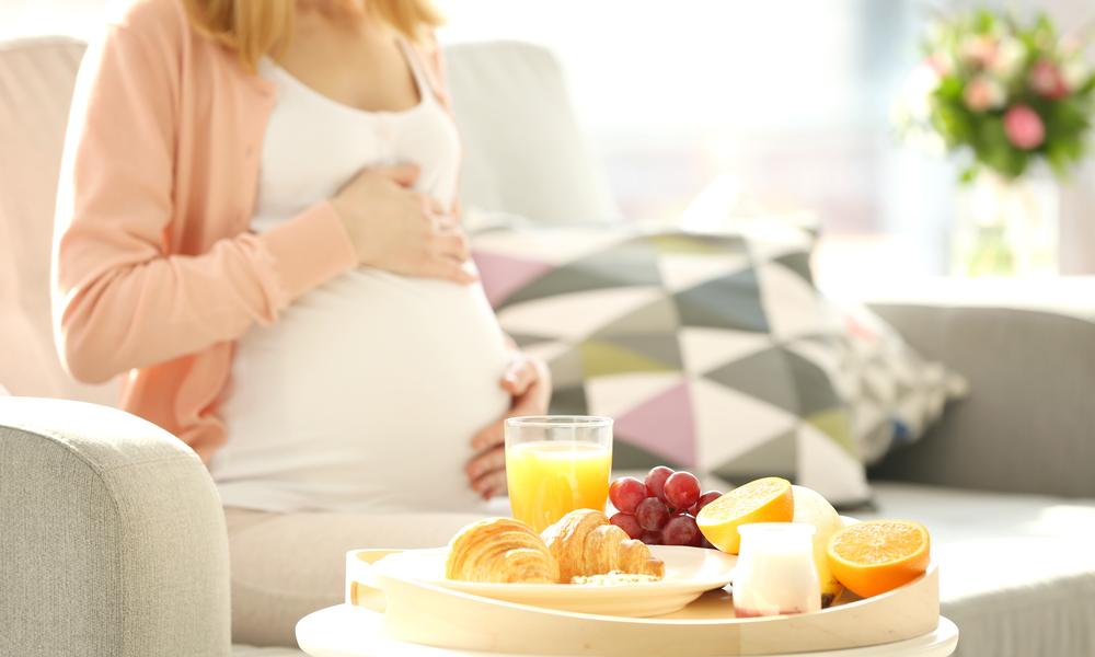 Pregnant lady eating fruit