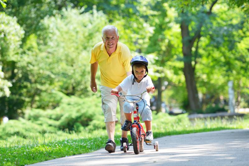 Older man with child on bike