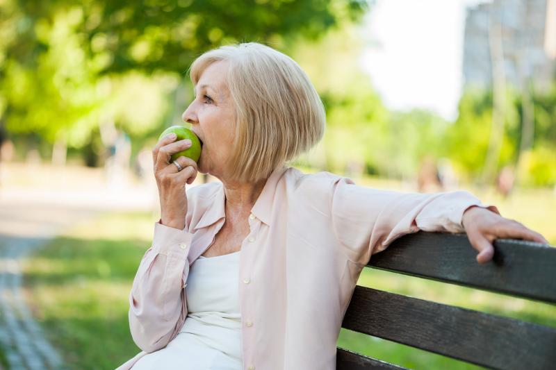 Older lady eating apple