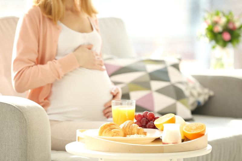 Pregnant lady eating fruit